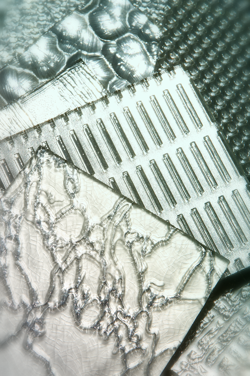 Close-up detail of layered decorative glass textures and patterns showcasing ADG's architectural glass craftsmanship